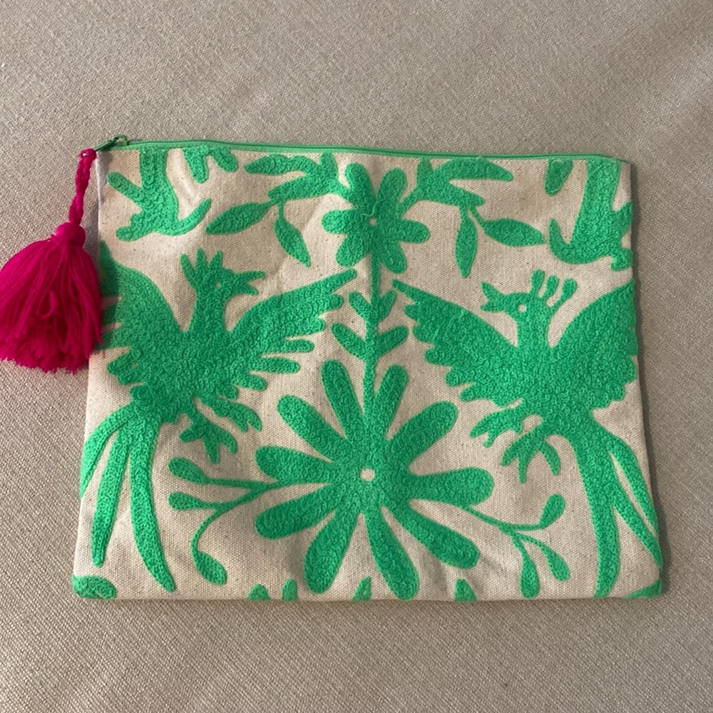 Green and white zipper clutch with pink tassel